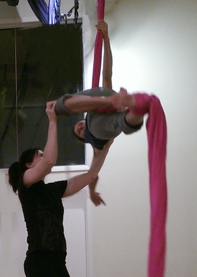 teacher spotting aerial silks student in class near me